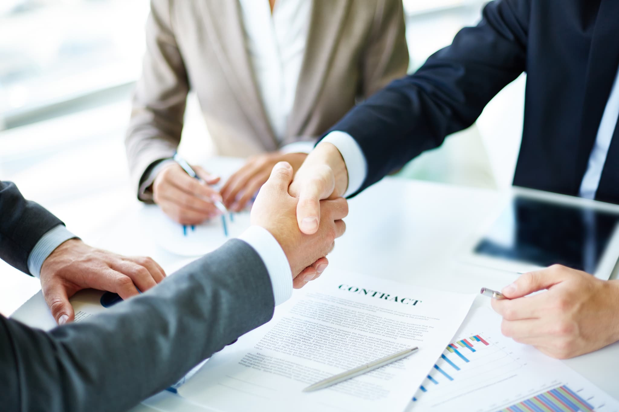 Hands shaking in agreement over a contract
